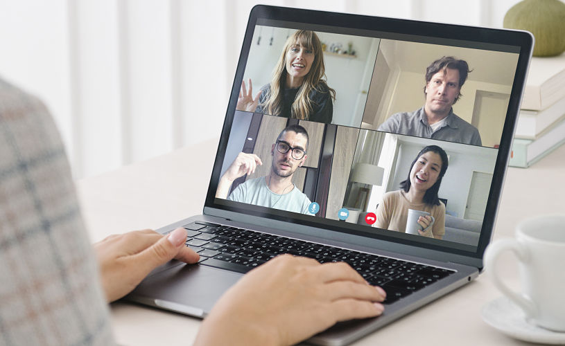 Delegates attend a hybrid event via an online platform, shown on a computer screen